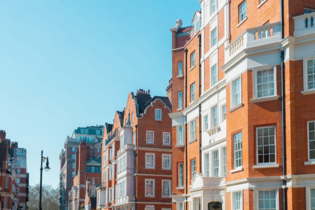 Summer maintenance for central London residential blocks: red-brick apartment buildings on a clear summer day